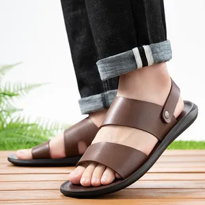 Detailed view of comfortable brown men's beach sandals with soft soles on a wooden floor