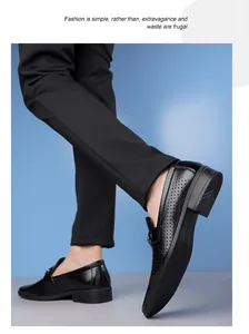 Dynamic low angle view of black hollow-out business casual loafers with metal buckle