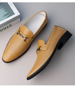 Close-up of yellow perforated leather loafer with elegant gunmetal horsebit buckle