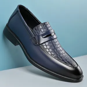 Detail showing navy blue business loafers with embossed circular texture on the vamp.