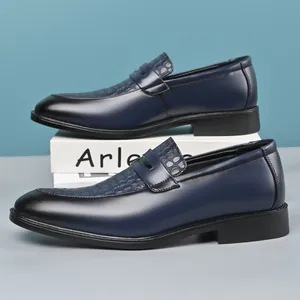 Detail view of navy blue men's leather loafers featuring crocodile embossed pattern