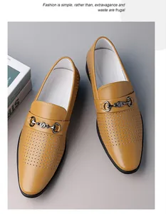 Macro view of breathable perforated mustard yellow loafers with a metal bit buckle