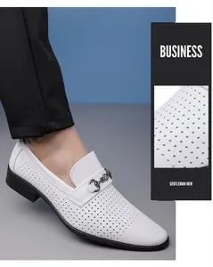 Close-up of white perforated business loafers with metal buckle for men