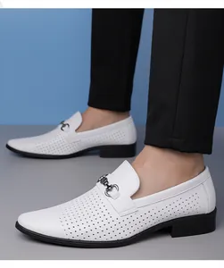 Detail of white perforated leather business casual shoes featuring a classic metal buckle.