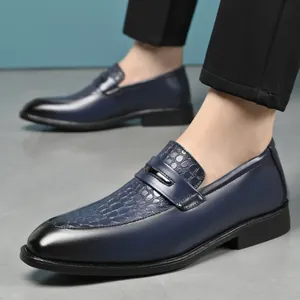 Detail view of navy blue men's leather loafers with crocodile texture and gradient toe.