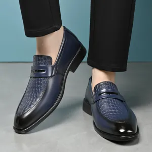 Detail shot of navy blue loafers with embossed crocodile texture and black gradient toe
