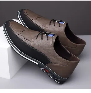 Dettaglio scarpe brogue da uomo bicolore marrone e nero con design a coda di rondine