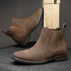 Detailed view of brown faux suede men's Chelsea boots with elastic side panels.