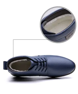 Detail showing soft warm white fuzzy lining inside blue leather men's ankle boots