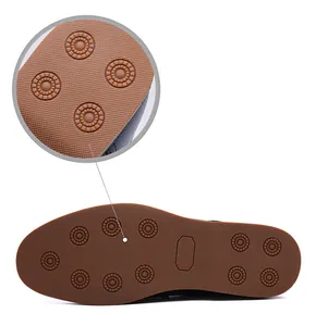 Detailed view of durable rubber sole with anti-slip tread pattern on men's leather boots