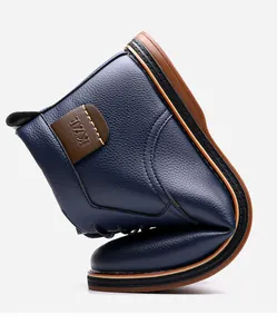 Close-up showing the extreme flexibility and soft leather of navy blue high-top boots.