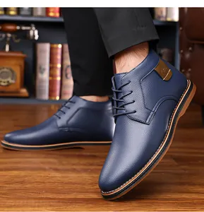 Detailed view of navy blue high-top men's business casual leather boots on feet