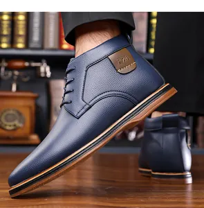 Macro view of navy blue men's business casual high-top leather boots with laces