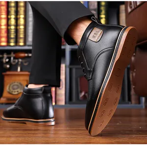 Detailed view of men's black high-top business casual leather boots with non-slip sole