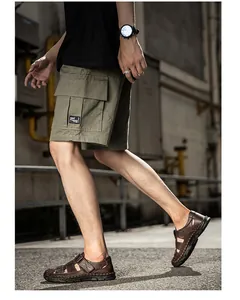 Side view detail of men's brown genuine leather closed-toe casual beach sandals.