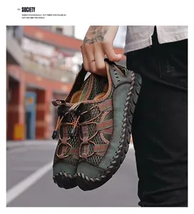 Close-up detail of men's breathable leather outdoor sports sandals held by hand