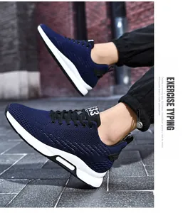 A detailed view of stylish navy blue knit elevator sneakers for men in a modern urban setting.