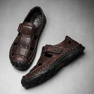 Macro view of men's brown leather closed-toe casual sandals with hand-stitched details