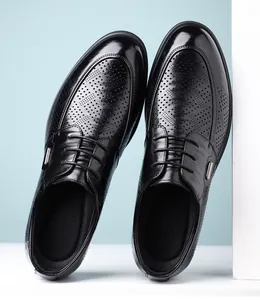 Close-up of retro hand-grab texture and hollow perforations on black men's leather shoes