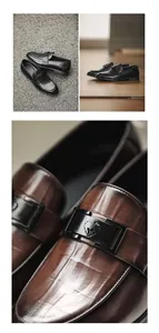 Close-up of elegant brown leather loafers showing embossed texture and buckle detail