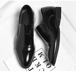 Detailed view of black shiny men's pointed toe slip-on dress shoes in British style