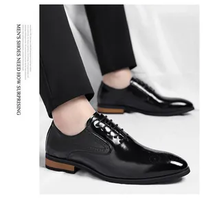 Elegant black patent leather men's Oxford shoes featuring intricate brogue detailing