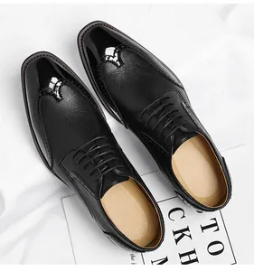 Close-up detail of premium black brogue dress shoes with glossy patent leather toe