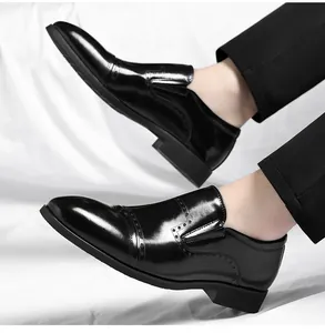 Close-up detail of black men's business slip-on dress shoes with classic brogue styling