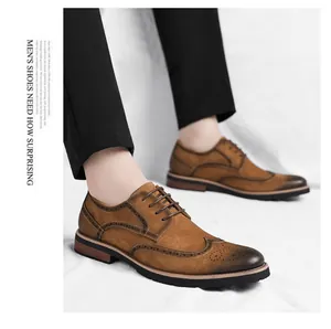 Detail of brown suede men's brogue shoes featuring elegant decorative wingtip punch patterns
