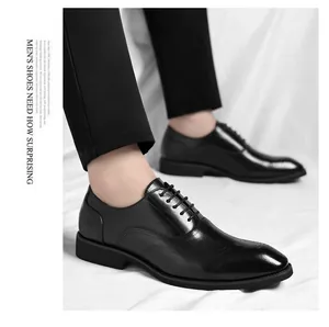 Close-up detail of black leather men's business dress shoes with brogue patterns on feet