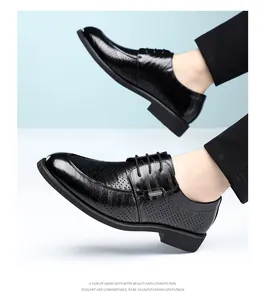 Side view of black perforated leather business shoes with elegant hand-rubbed texture