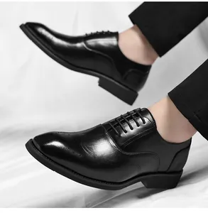 Close-up detail of black leather Oxford shoes for men with elegant brogue patterns