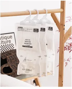 Close-up of hanging moisture absorber bags with 500ml capacity on a wooden clothes rack