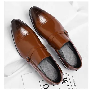 Elegant brown formal men's shoes with embossed crocodile texture and glossy finish