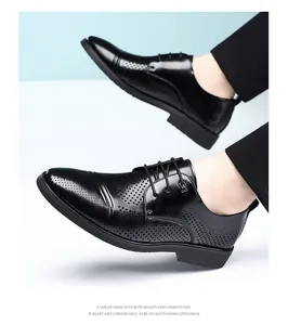 Close-up detail of stylish black leather Derby shoes featuring elegant perforated designs