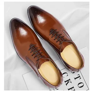 Top view of brown leather Oxford shoes with brogue detailing and polished finish
