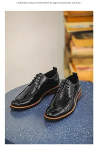 Shiny black men's business leather shoes displayed on a textured blue table surface