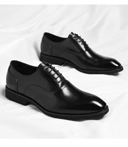 Elegant black leather brogue oxfords on white silk background