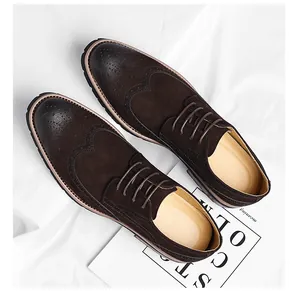 Close-up of premium men's dark brown suede wingtip brogue oxford shoes from above