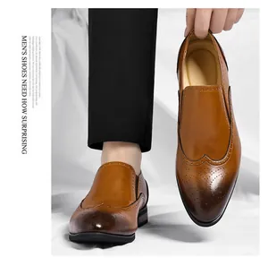 Dettaglio scarpe Oxford marroni da uomo con eleganti decorazioni brogue intagliate