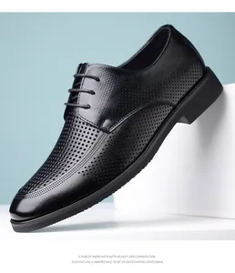 Detailed macro shot of black perforated leather dress shoes for men with lace-up design