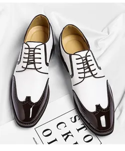 Top down detail view of men's two-tone white and brown Brogue leather dress shoes