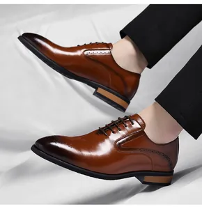 Detailed view of brown men's formal Oxford shoes with brogue patterns and polished finish