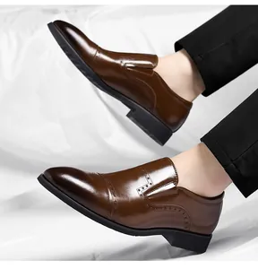 Detailed view of polished brown men's slip-on dress shoes featuring elegant brogue wingtip design