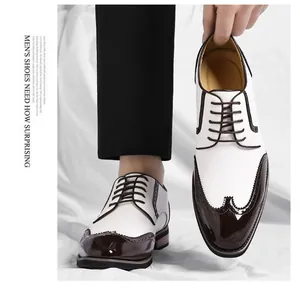 Detailed view of two-tone white and brown wingtip brogue dress shoes