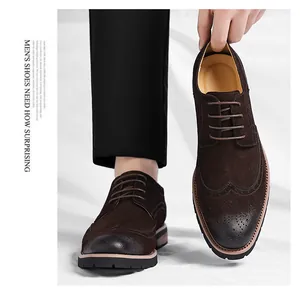 Detail of brown suede brogue oxford shoes with decorative wingtip perforations