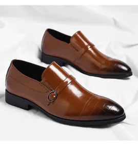 Detail view of brown men's formal dress shoes with crocodile texture toe cap.