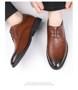 Close-up of brown perforated leather business dress shoes with elegant lace-up closure