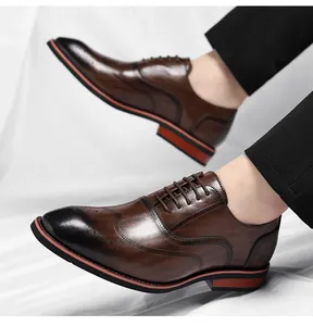 Detailed macro view of brown men's brogue dress shoes with classic wingtip engraving