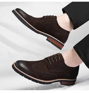 Side view detail of brown suede brogue oxford shoes with elegant wingtip carving.